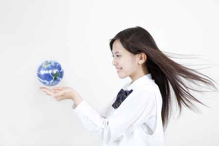 High school girls with a globeの写真素材