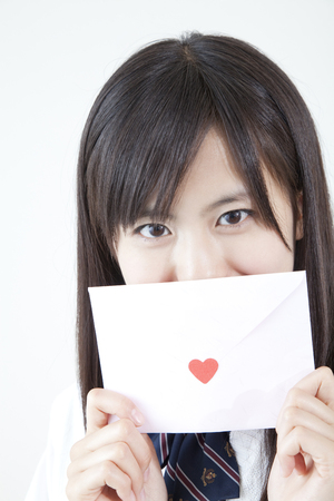High school girls with a love letterの写真素材