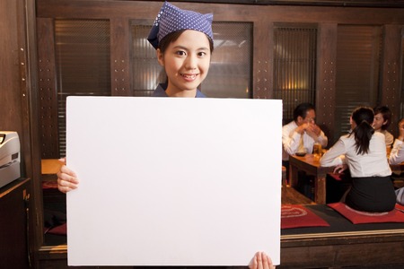 Tavern clerk smiling with a message boardの写真素材