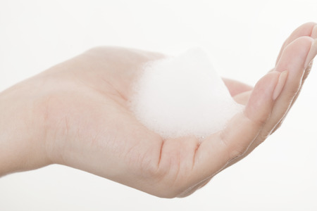 Hand of the woman to put the foamの写真素材
