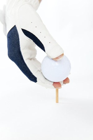 Hand of the woman who set the golf ballの写真素材