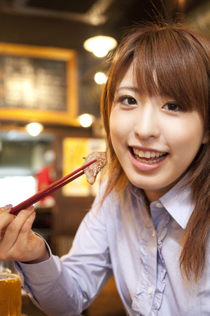 Women eat meatの写真素材