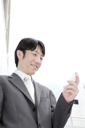 Businessmen working with smart phonesの写真素材