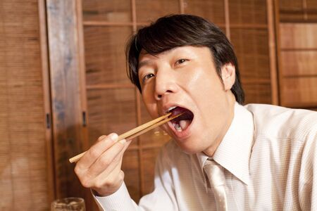 Businessman eating cuisineの写真素材