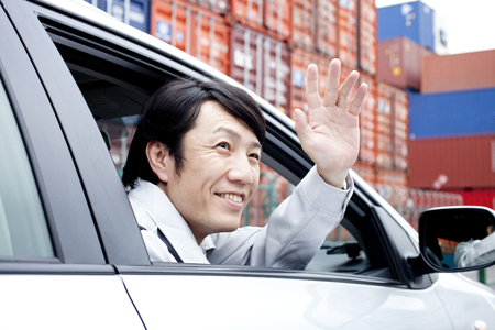 Workers waving from carの写真素材