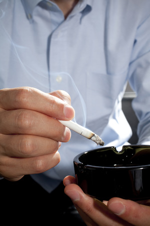 Hand men smother tobaccoの写真素材