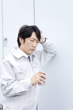 Workers drink canned coffeeの写真素材