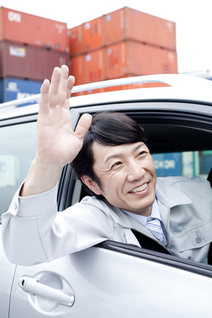 Workers waving from carの写真素材