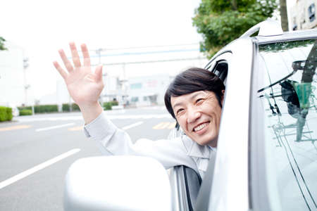Workers waving from carの写真素材