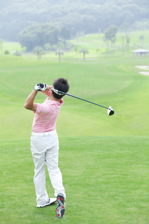 Man hit tee shotsの写真素材