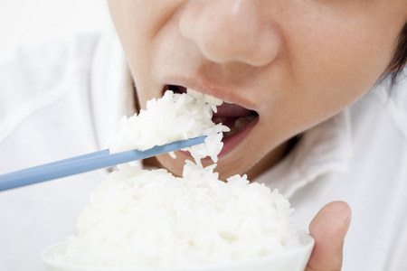 Men eat white riceの写真素材