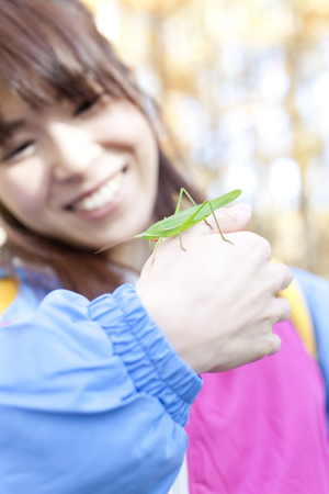 Women who put the grasshopper in handの写真素材
