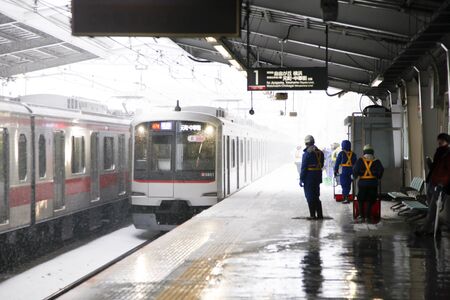 train arriving at the station in Tokyo that snowのeditorial素材