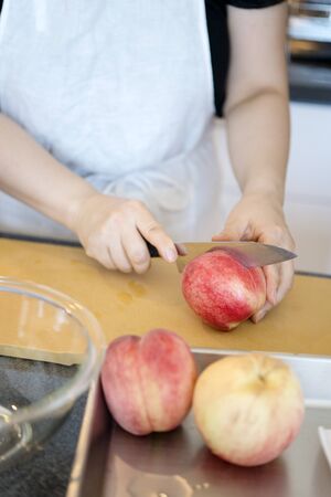 Women who cut the peachesの写真素材