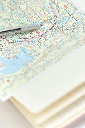 Notebook and ballpoint pens and mapsの写真素材