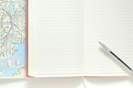 Notebook and ballpoint pens and maps