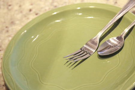 Green color dish and spoon and forkの写真素材