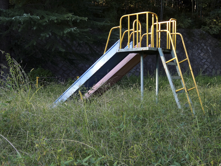 Park playground equipment in the weedsの写真素材