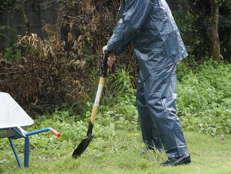 Japanese to work wearing a raincoatの写真素材