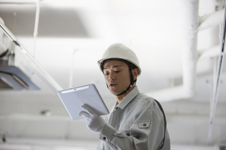 Male workers to use a Tablet PCの写真素材