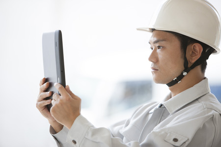 Male workers to use a Tablet PCの写真素材