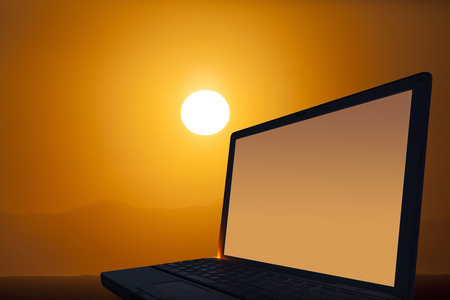 Laptop and sunsetの写真素材