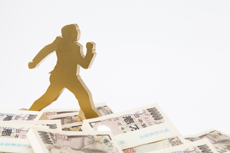 Figure of businessman running through the wadの写真素材