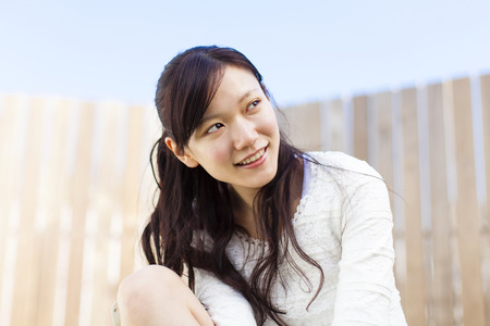 Woman sitting in an outdoor Chairの写真素材