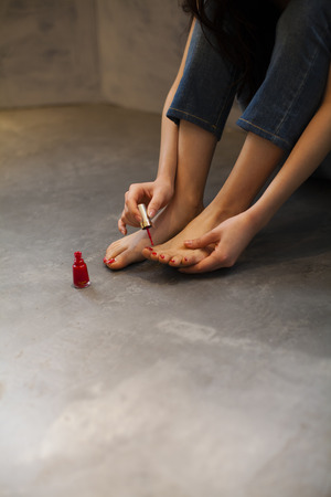 Woman painting the pedicureの写真素材