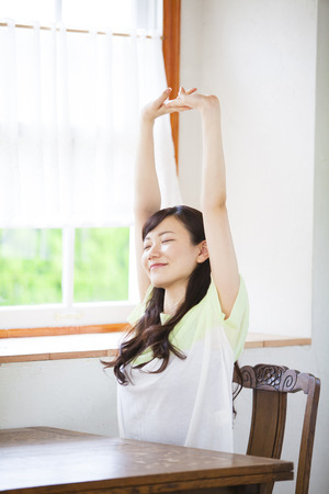 Women sit on the windowsillの写真素材