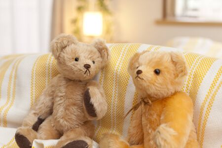 Teddy bear sitting on the bedの写真素材