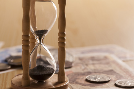 An hourglass and money