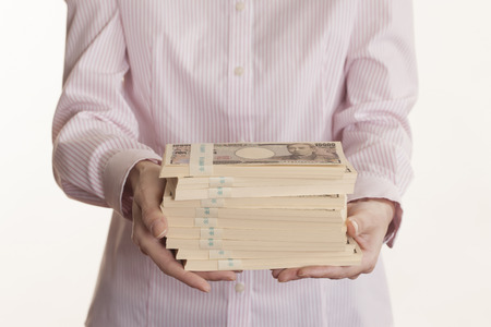 Women with bundle of billsの写真素材