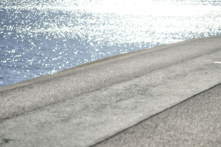 Water surface sparkle and promenadeの写真素材