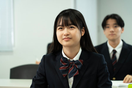 Asian teenagers in high school uniforms studying in classの写真素材