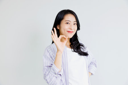 Asian woman with okay gestureの写真素材