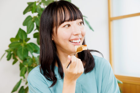 Asian woman having lunch in a restaurantの写真素材