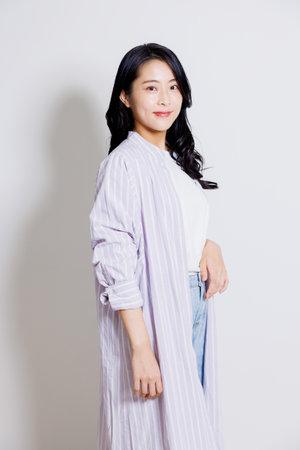 Studio shot portrait of Asian woman in casual clothingの写真素材