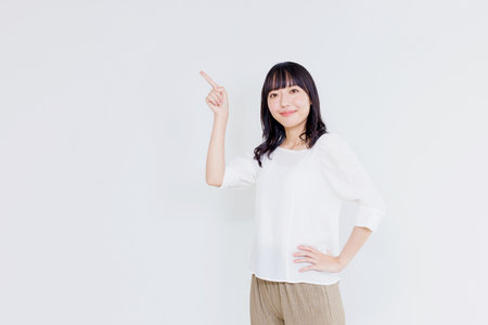 Asian woman with pointing gestureの写真素材