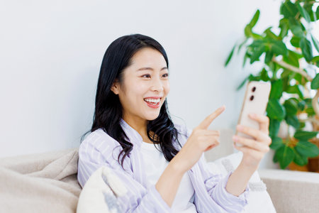 Asian woman using her mobile phoneの写真素材