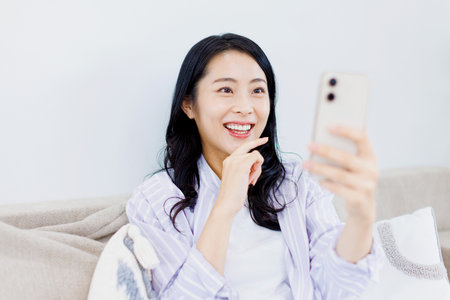 Asian woman using her mobile phoneの写真素材