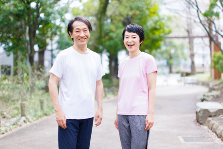 Mature Japanese couple in sportswear at a parkの写真素材