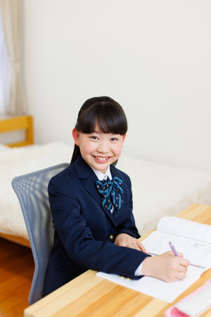 Japanese girl in school uniform studyingの写真素材