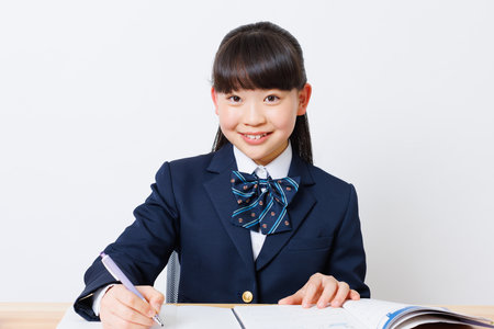 Japanese girl in school uniform studyingの写真素材