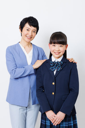 Portrait of Japanese girl in school uniform with her grandmotherの写真素材