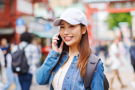 Asian woman talking on phoneの写真素材