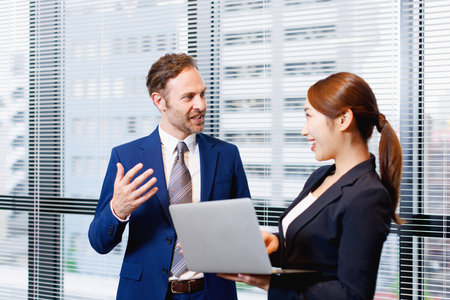 Businessman and businesswoman having discussion in the officeの写真素材
