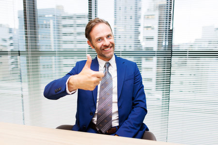 Businessman showing thumbs up gestureの写真素材