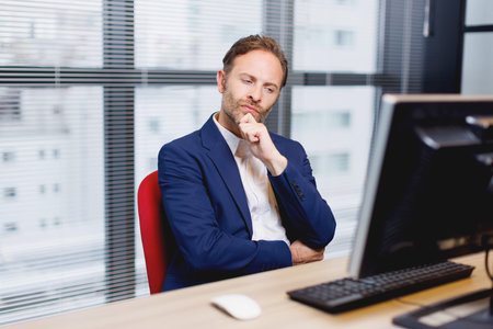 Caucasian man at work contemplatingの写真素材