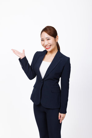 Asian woman in formal wear with showing poseの写真素材